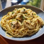 A close-up of Creamy Chicken Pasta with White Wine Parmesan Sauce, garnished with fresh parsley.