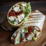 Close-up of Delicious Chicken Caesar Salad Wraps filled with grilled chicken, lettuce, and sun-dried tomatoes.