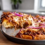 A slice of Flavorful BBQ Chicken Pizza Homemade Delight, with melted cheese stretching.