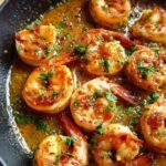 Close-up of Irresistible Lemon Garlic Shrimp Skillet, cooked in a buttery sauce with parsley.