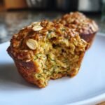 Close-up of an Irresistible Zucchini Oatmeal Muffin, showing its moist texture and shredded zucchini.