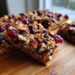 Close-up of delicious Keto Cranberry Pecan Magic Bars topped with pecans, cranberries, and chocolate chips.