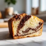 Close-up of a slice of Marble Cake, showcasing the beautiful chocolate and vanilla swirls.
