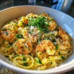 A close-up of creamy Marry Me Shrimp Pasta, topped with fresh parsley and grated Parmesan cheese.
