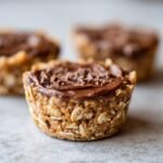 Close-up of an irresistible easy no bake peanut butter oat cup topped with chocolate and sprinkles.