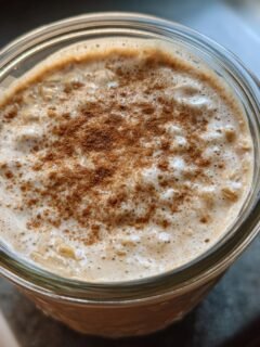Close-up of delicious protein overnight oats in a jar, topped with cinnamon.