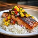 Close-up of Irresistible Grilled Salmon with Mango Salsa served over fluffy coconut rice.
