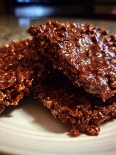 Close-up of a stack of Irresistible Quinoa Chocolate Crisps on a white plate.