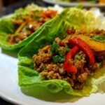 Close-up of savory ground meat filling with peppers served in crisp lettuce cups, perfect for Weight Watchers Lunch Recipes.