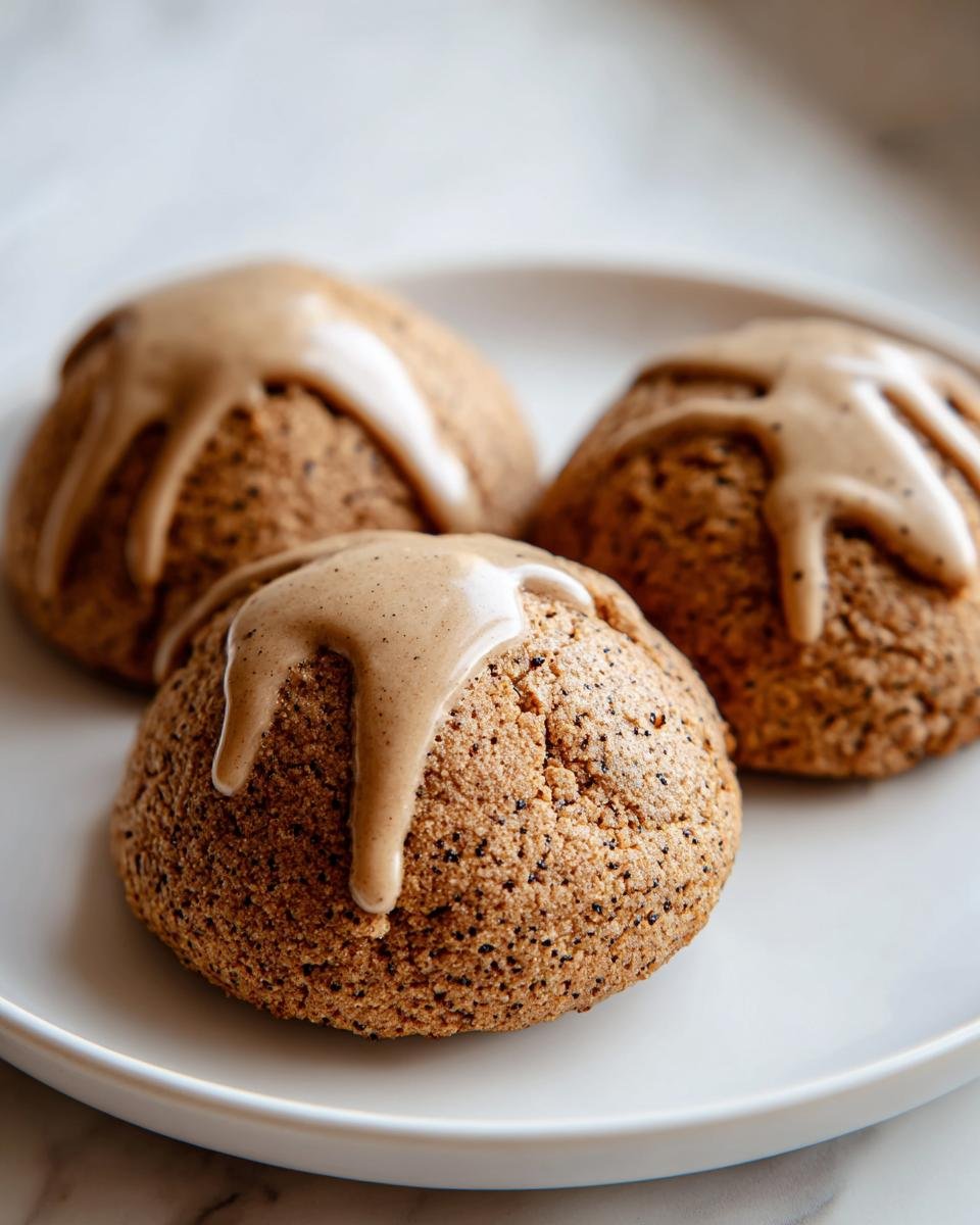 Three dome-shaped Gingerbread Latte Cookies topped with a thick, spiced coffee-colored glaze drizzle.