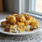A generous serving of Chicken Bacon Ranch Tater Tot Casserole topped with crispy tater tots and melted cheddar cheese.